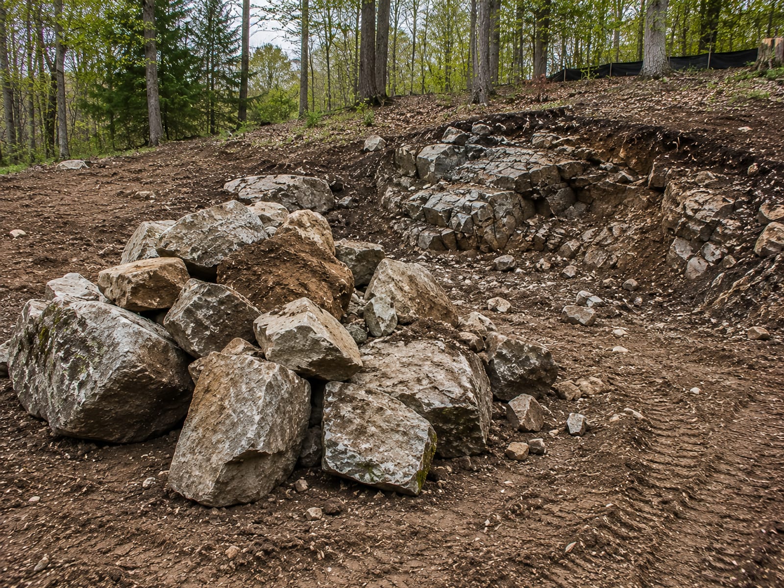Large granite boulders and broken ledge rock extracted from a residential lot in western Connecticut